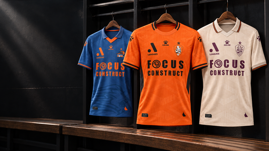 Brisbane Roar 2026-27 Kelme home, away and third jerseys in a football dressing room